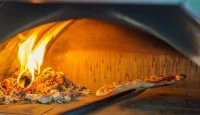 Pizza in oven &copy; Freepik